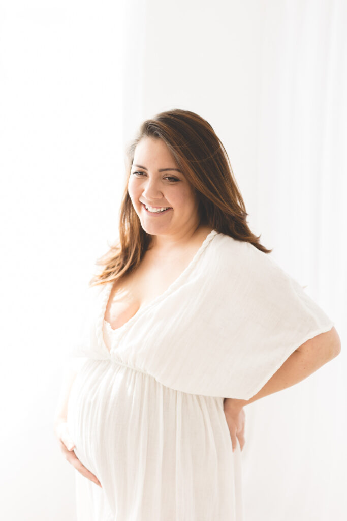 Pregnant Mama in white dress, smiling