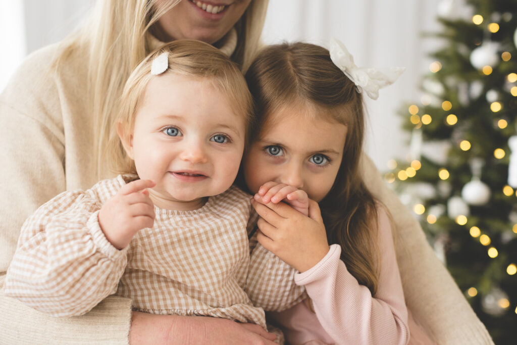 Sisters in front of Christmas tree