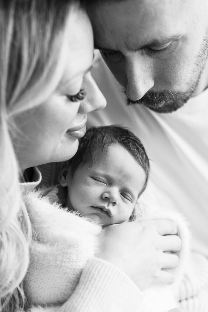 Close up of Mum, Dad and newborn baby in black and white