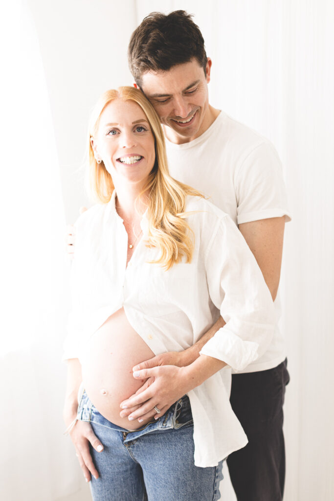image of couple with hands on pregnant bump