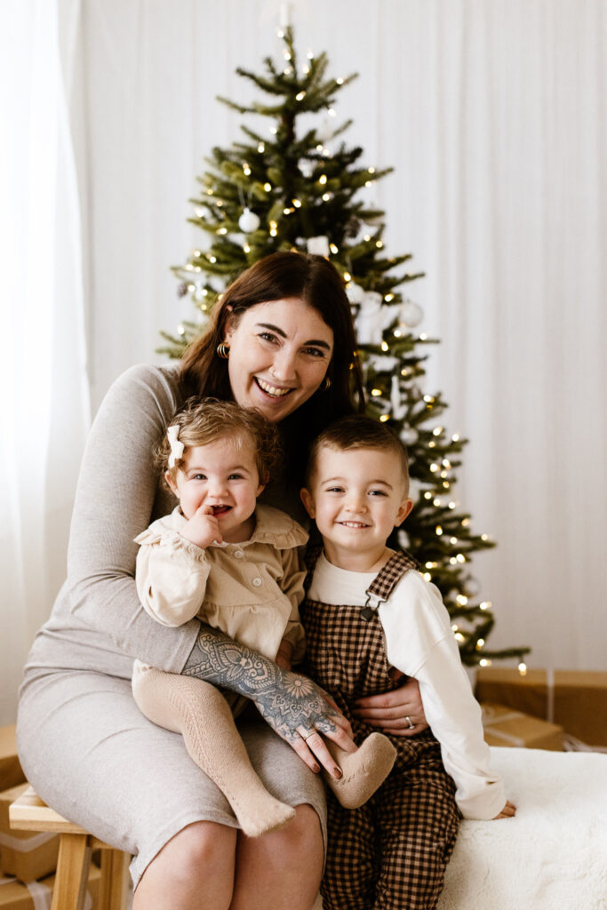 Mum with 2 children and christmas tree