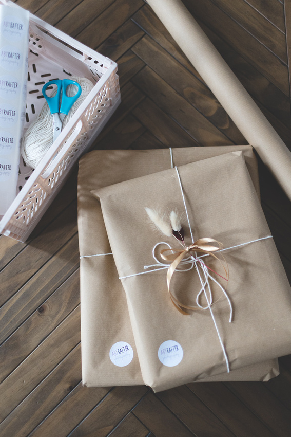 Packaged framed prints in brown paper packaging tied up with string.