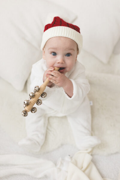 Santa baby chewing Christmas sleigh bells